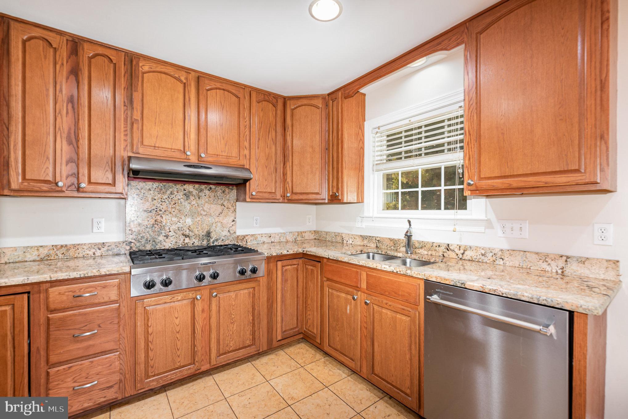 4617 Forge Road Perry Hall, MD 21128 - Photo 18 of 44 a kitchen with stainless steel appliances granite countertop a sink stove and cabinets