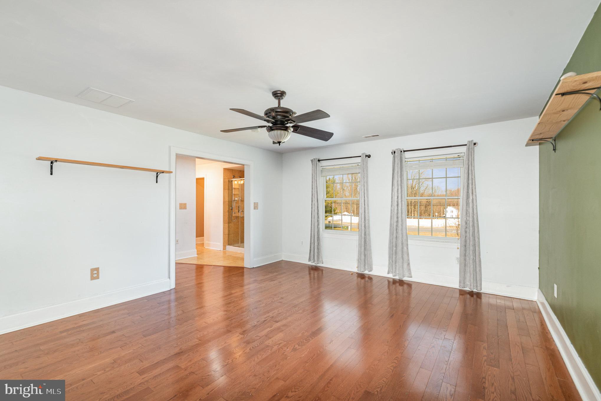4617 Forge Road Perry Hall, MD 21128 - Photo 21 of 44 a view of an empty room with wooden floor and a window