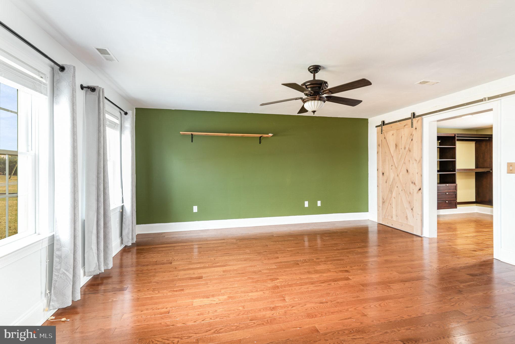 4617 Forge Road Perry Hall, MD 21128 - Photo 22 of 44 a view of an empty room with window and wooden floor