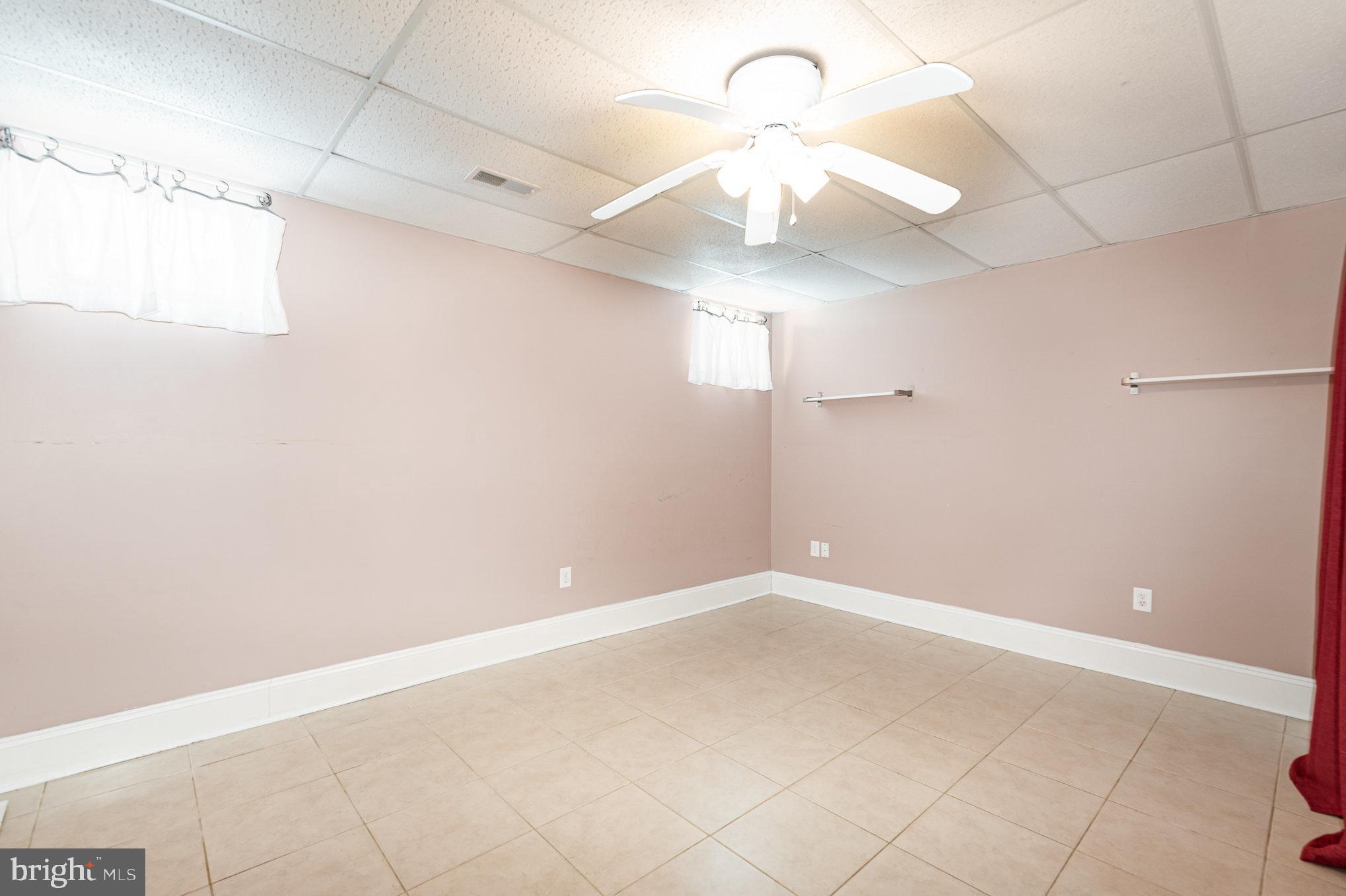 4617 Forge Road Perry Hall, MD 21128 - Photo 33 of 44 an empty room with a ceiling fan and a window