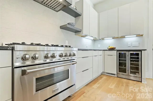 a kitchen with granite countertop a stove and a sink