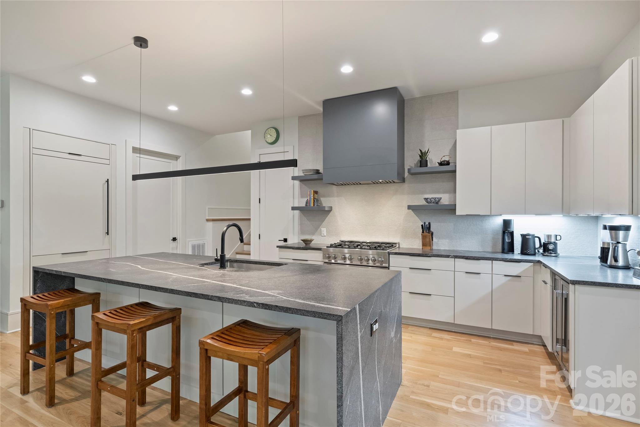 7223 Terrace Drive Charlotte, NC 28211 - Photo 12 of 48 a kitchen with stainless steel appliances granite countertop a sink a stove a refrigerator island and chairs