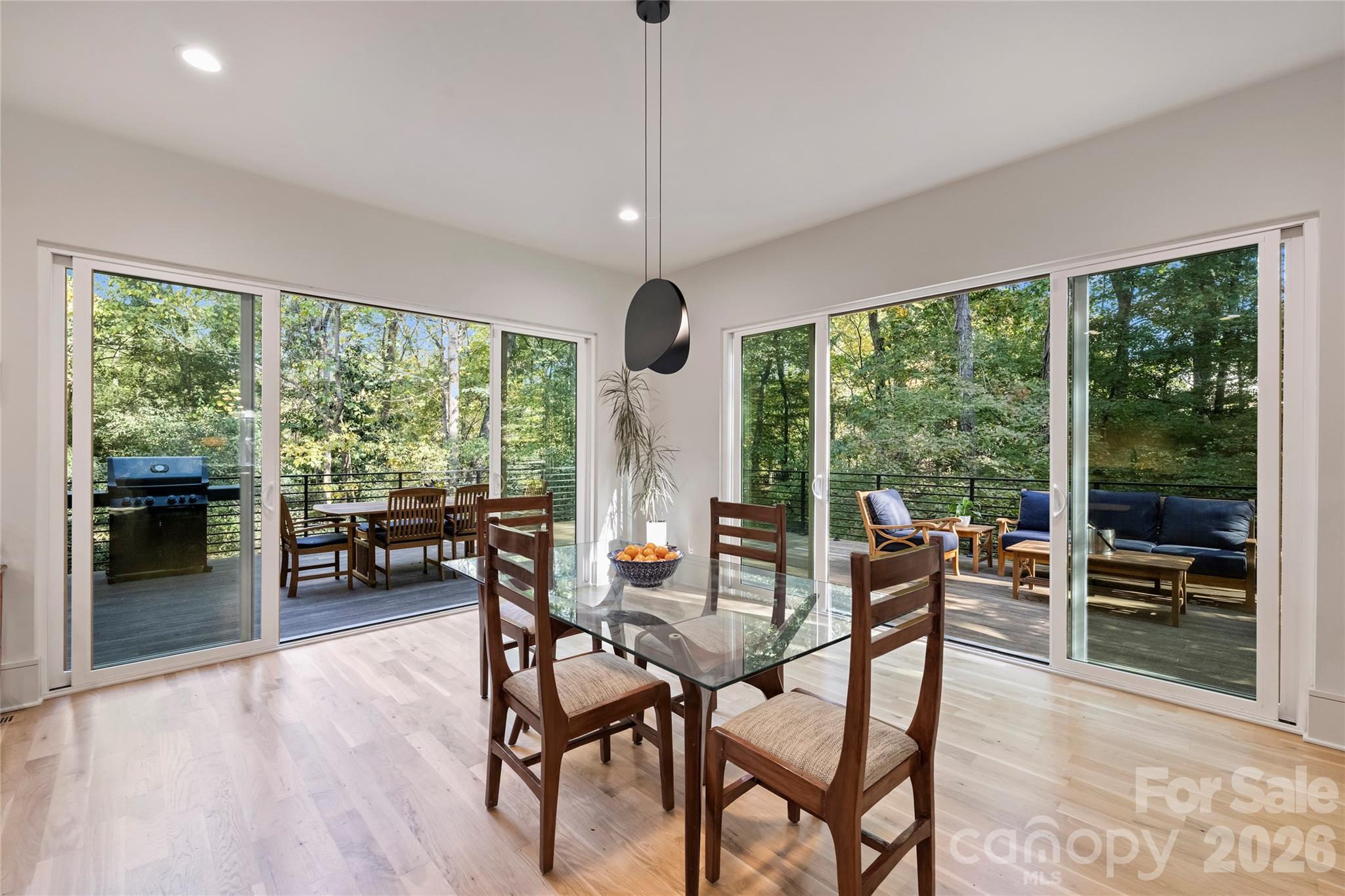 7223 Terrace Drive Charlotte, NC 28211 - Photo 16 of 45 a dining room with furniture water view and a floor to ceiling window