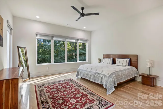 a bedroom with a large bed and a large window