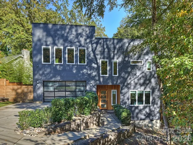 a front view of house with a garden