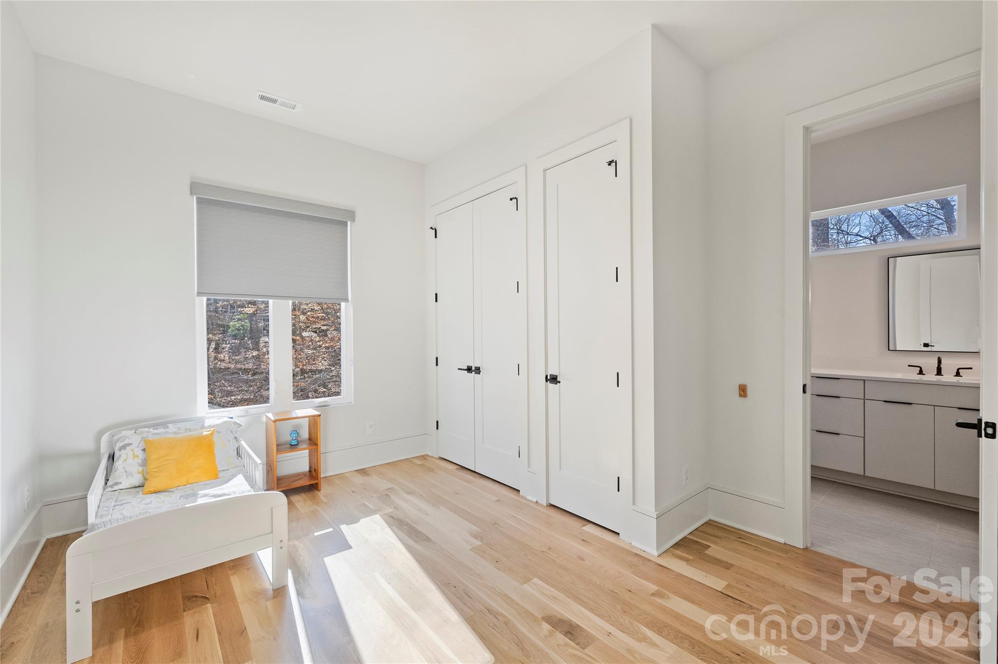 7223 Terrace Drive Charlotte, NC 28211 - Photo 31 of 45 a view of a bedroom with wooden floor and a bathroom