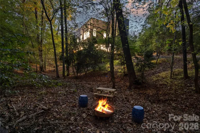 a view of house with yard and sitting area