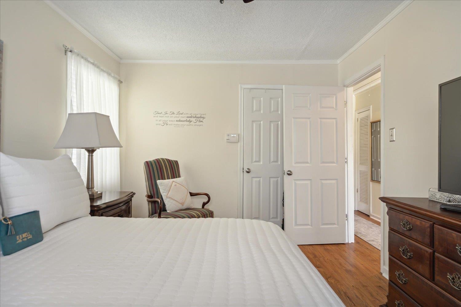 3274 Norton Road Memphis, TN 38109 - Photo 16 of 26 a bedroom with a bed and wooden floor