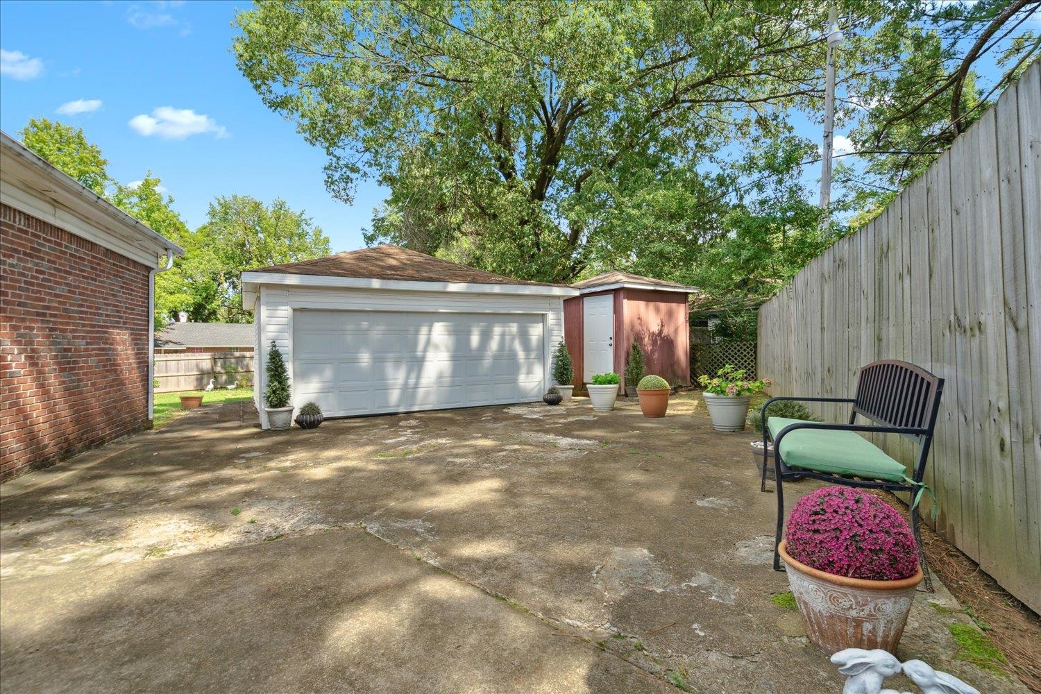 3274 Norton Road Memphis, TN 38109 - Photo 25 of 26 a view of a backyard with table and chairs potted plants and a large tree