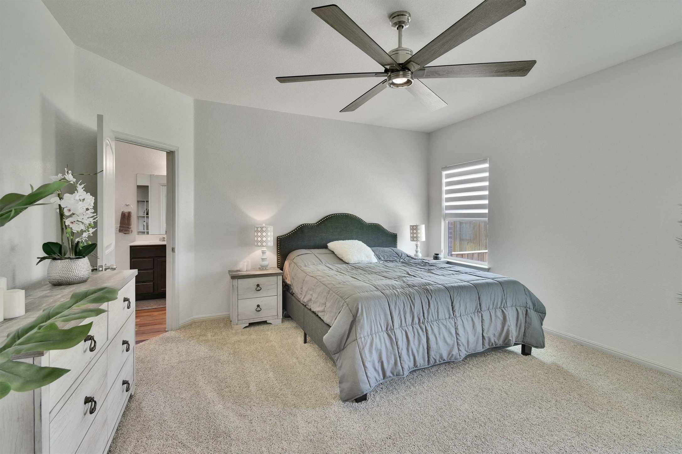 324 Shiner Lane Georgetown, TX 78626 - Photo 17 of 39 a bedroom with a bed and a chandelier
