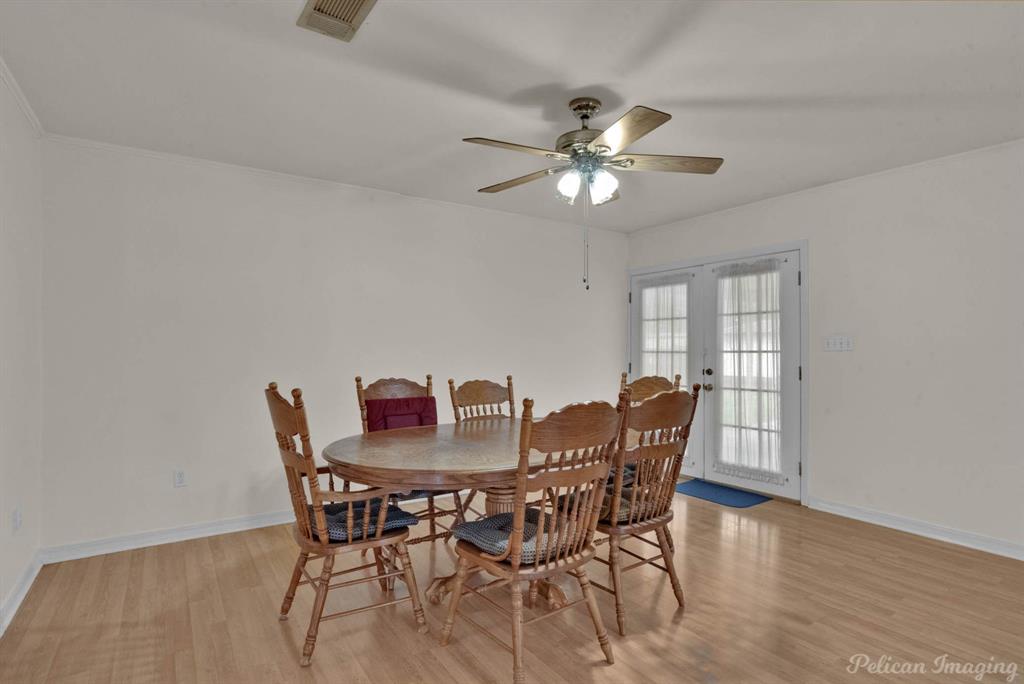 101 West Jefferson Street Haughton, LA 71037 - Photo 14 of 39 a dining room with furniture a chandelier and wooden floor