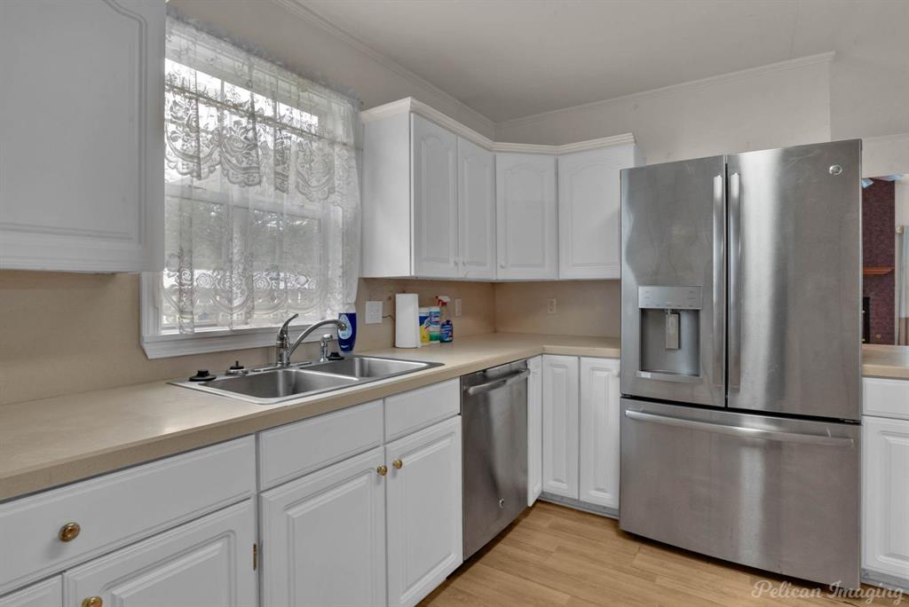 101 West Jefferson Street Haughton, LA 71037 - Photo 19 of 39 a kitchen with a refrigerator sink and cabinets