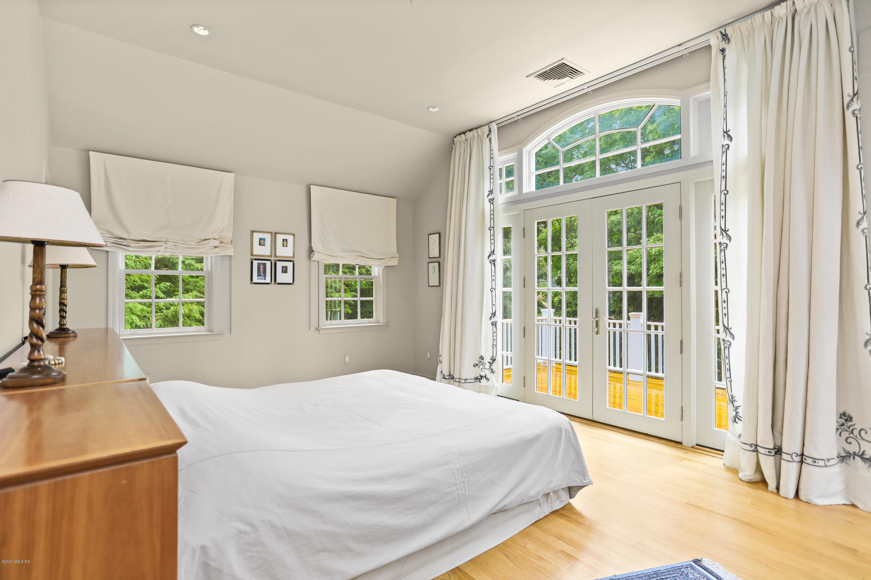 137 Clapboard Ridge Road Greenwich, CT 06831 - Photo 17 of 29 a bedroom with a bed and a large window