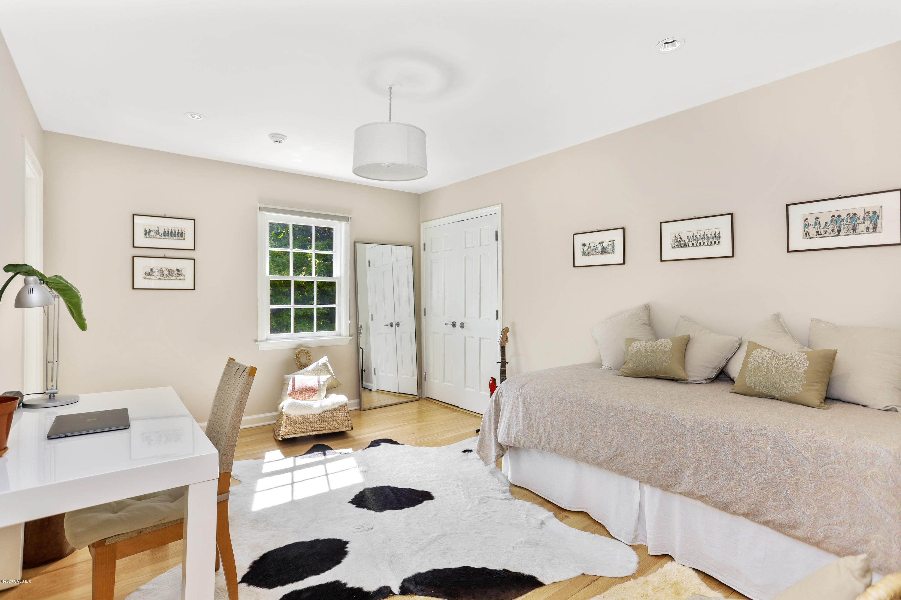 137 Clapboard Ridge Road Greenwich, CT 06831 - Photo 19 of 29 a bedroom with a bed a table and chair