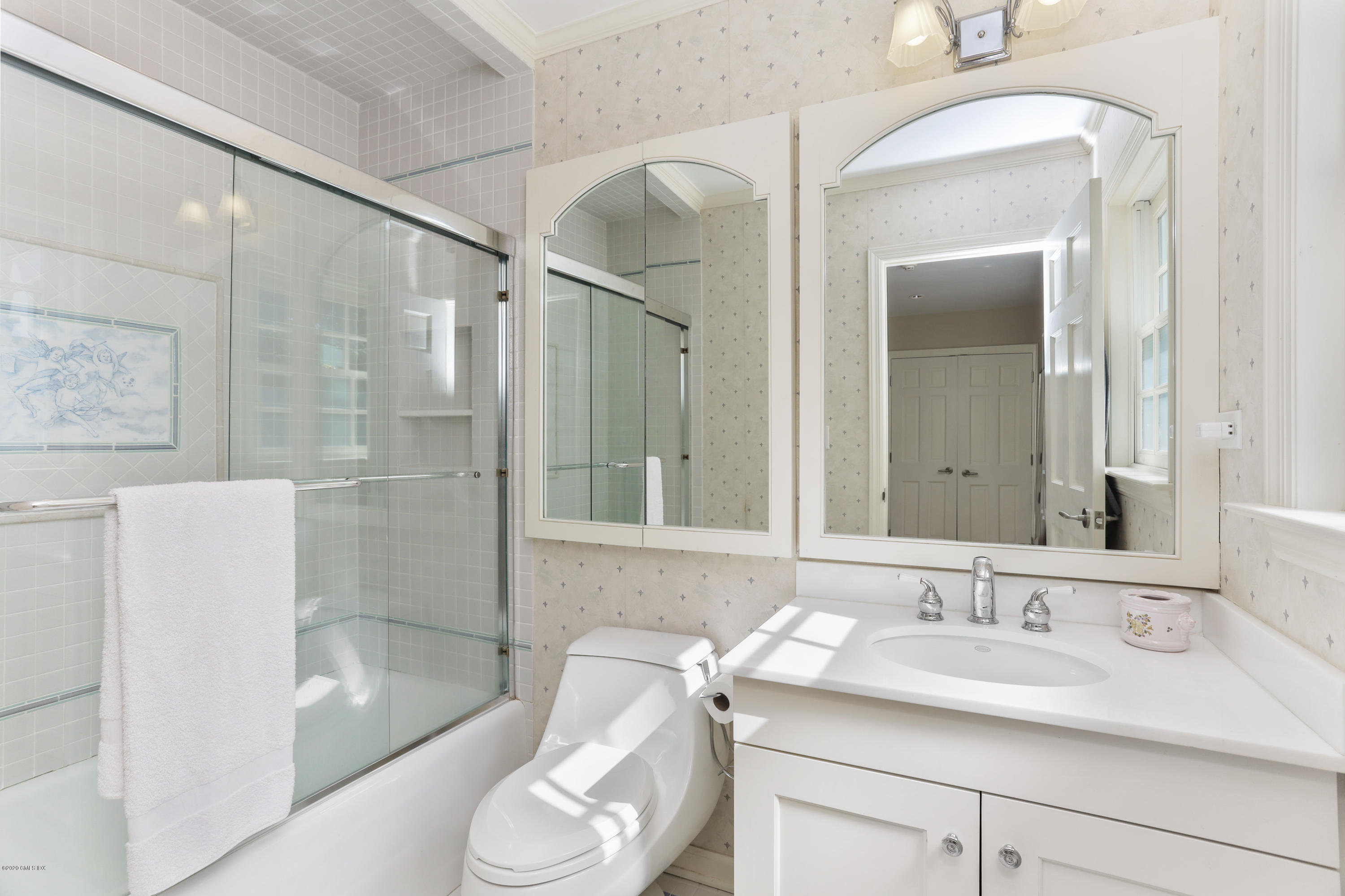 137 Clapboard Ridge Road Greenwich, CT 06831 - Photo 20 of 29 a bathroom with a sink and mirror with bathtub