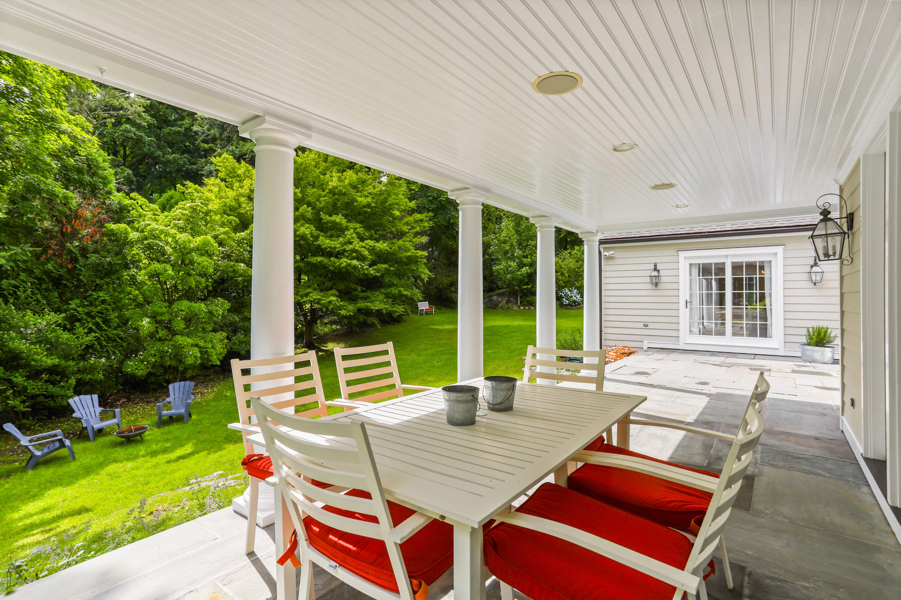 137 Clapboard Ridge Road Greenwich, CT 06831 - Photo 26 of 29 a view of a patio with a dining table and chairs