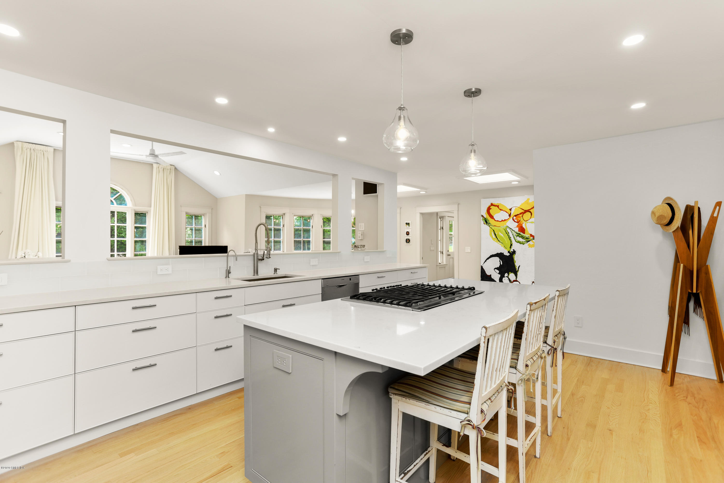 137 Clapboard Ridge Road Greenwich, CT 06831 - Photo 4 of 29 a kitchen with granite countertop white cabinets a stove a dining table and chairs