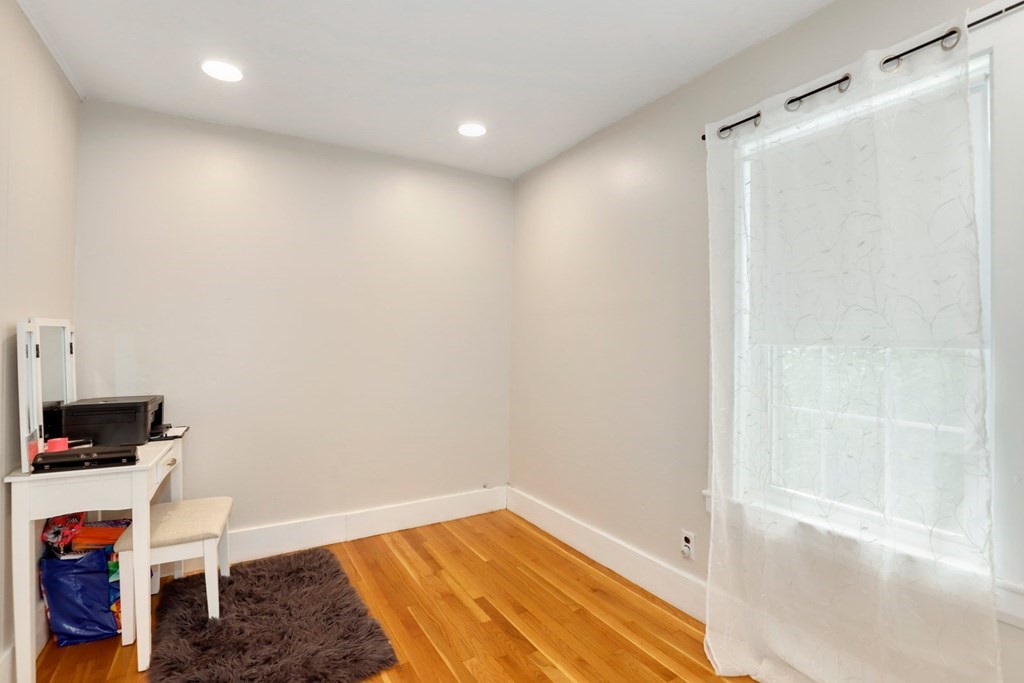 69 R Eastern Avenue Woburn, MA 01801 - Photo 11 of 35 a view of empty room with wooden floor and fan