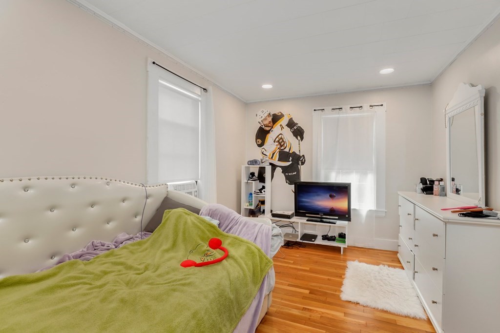 69 R Eastern Avenue Woburn, MA 01801 - Photo 13 of 35 a bedroom with a bed and a flat screen tv