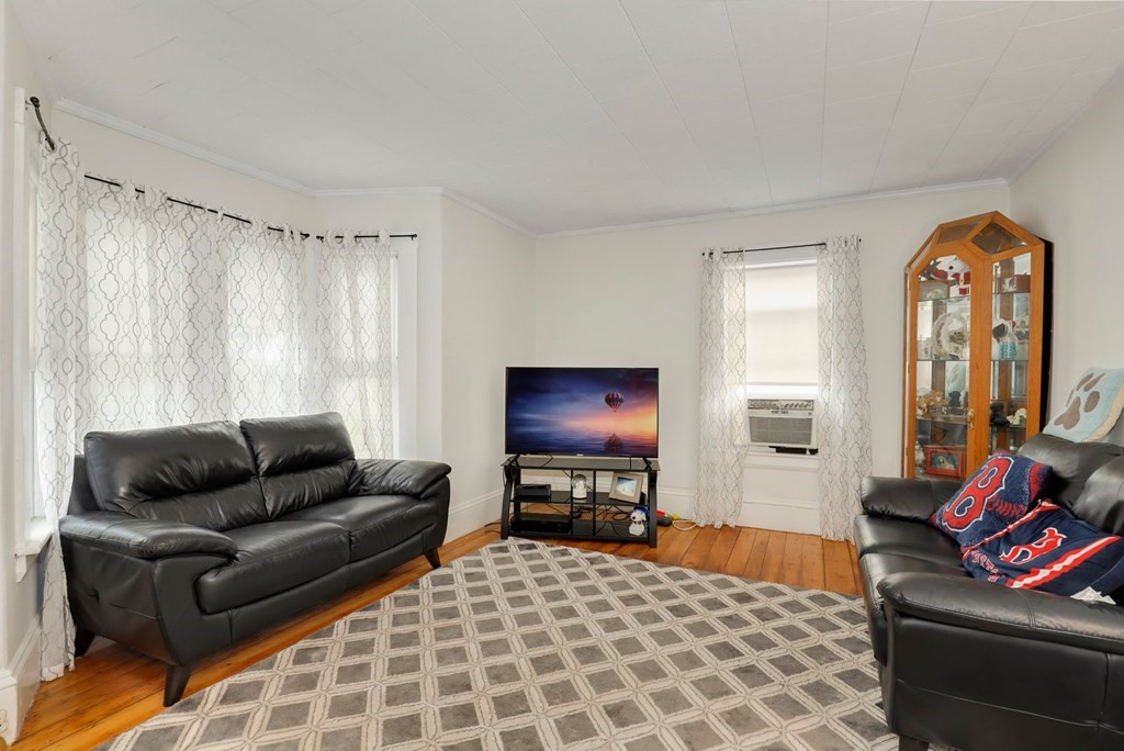 69 R Eastern Avenue Woburn, MA 01801 - Photo 14 of 35 a living room with furniture and a flat screen tv
