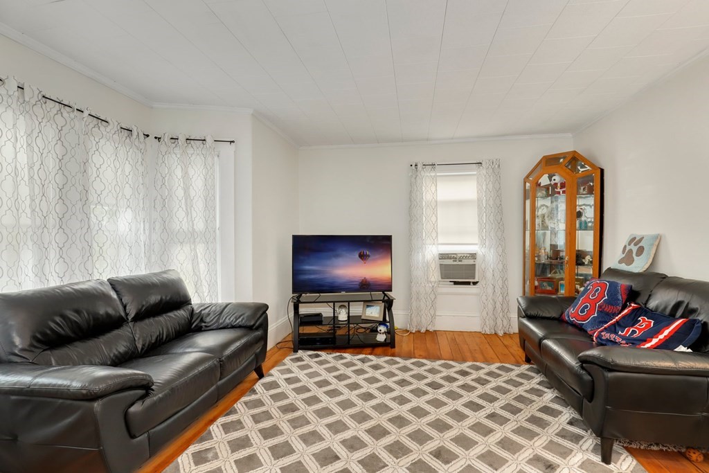 69 R Eastern Avenue Woburn, MA 01801 - Photo 15 of 35 a living room with furniture and a flat screen tv