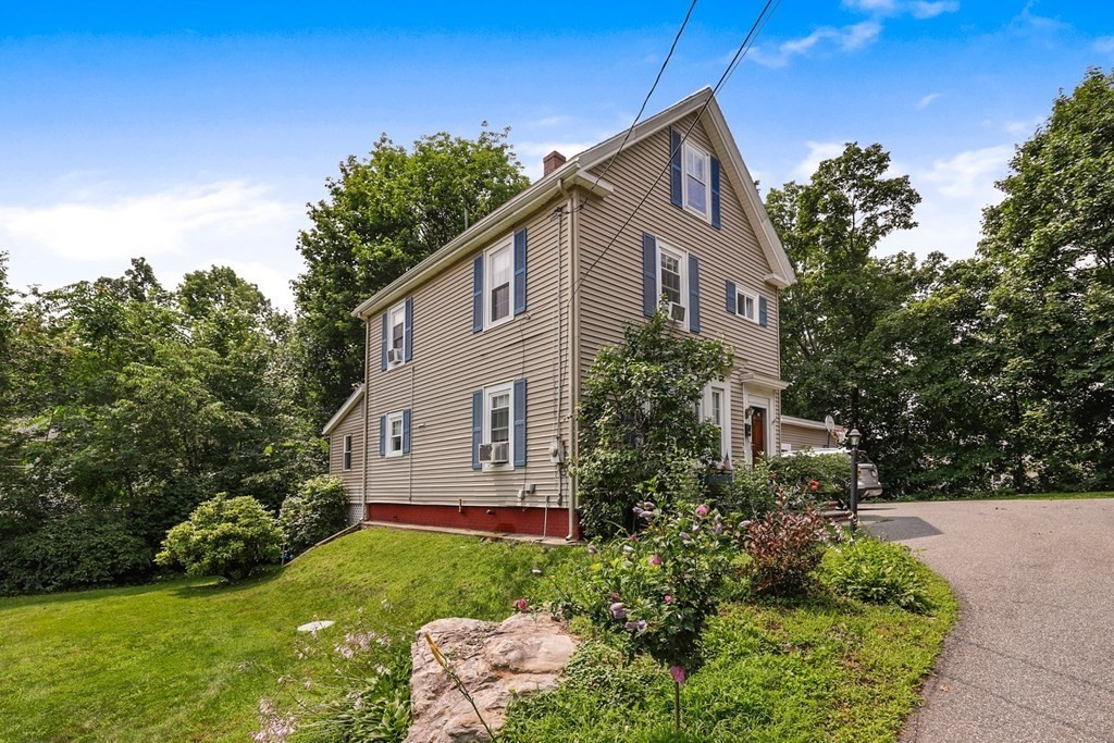 69 R Eastern Avenue Woburn, MA 01801 - Photo 2 of 35 a front view of a house with a yard