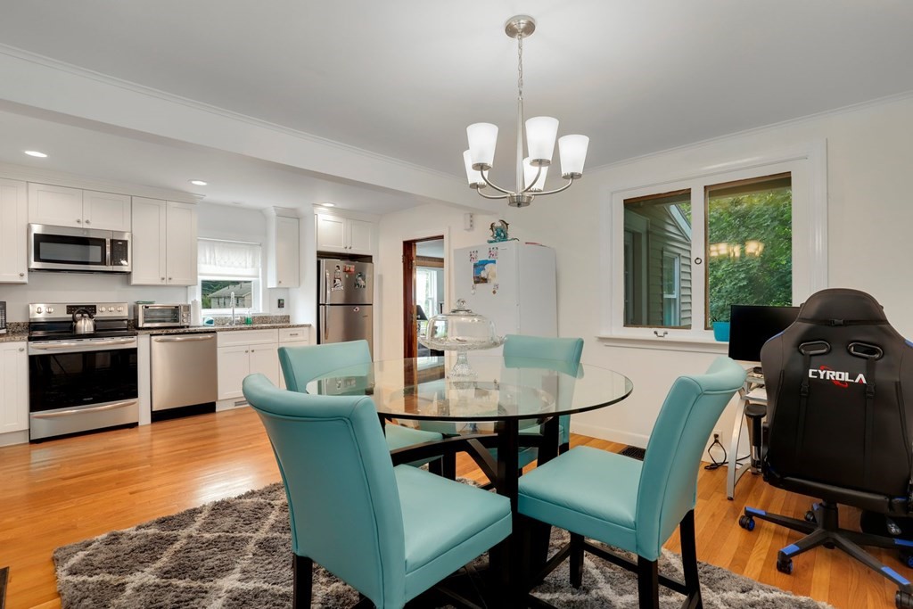 69 R Eastern Avenue Woburn, MA 01801 - Photo 22 of 35 a view of a dining room with furniture a chandelier and wooden floor