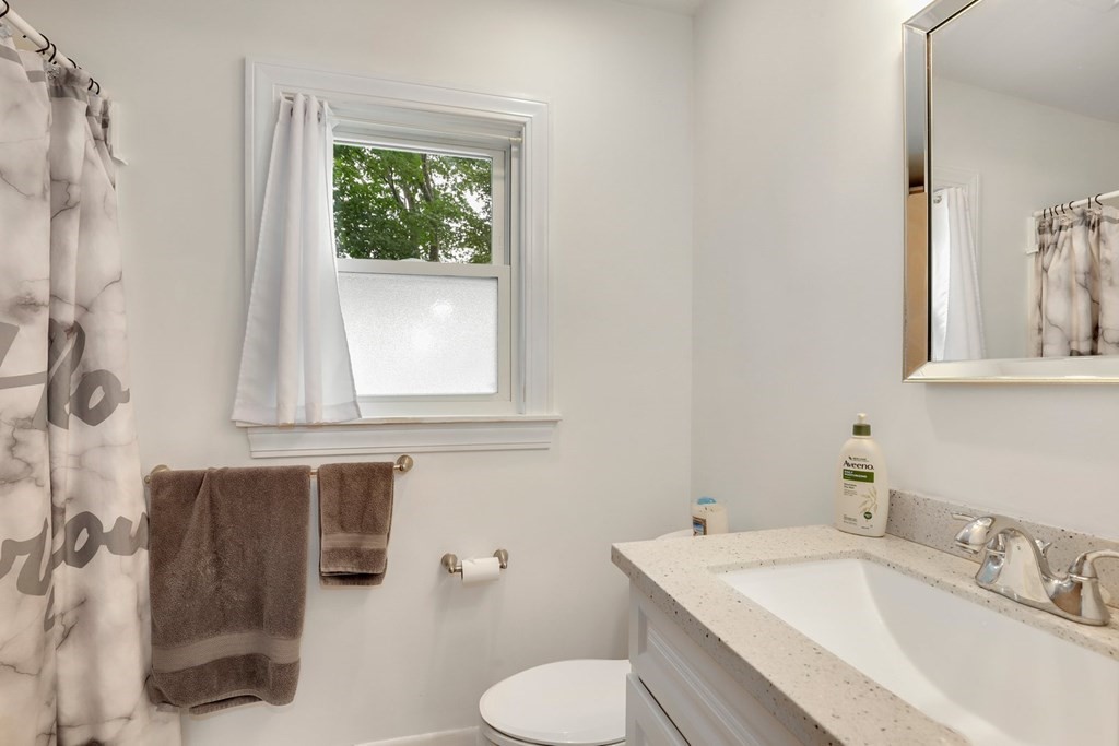 69 R Eastern Avenue Woburn, MA 01801 - Photo 23 of 35 a bathroom with a sink toilet and mirror
