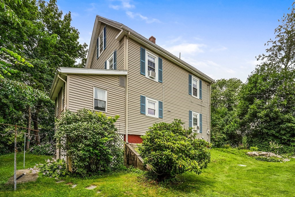 69 R Eastern Avenue Woburn, MA 01801 - Photo 32 of 35 a front view of a house with a yard