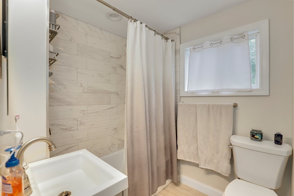 69 R Eastern Avenue Woburn, MA 01801 - Photo 6 of 35 a bathroom with a sink a toilet and a bathtub