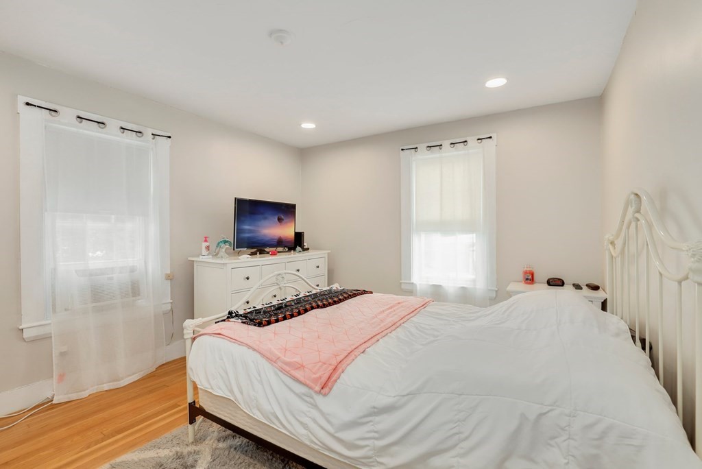 69 R Eastern Avenue Woburn, MA 01801 - Photo 8 of 35 a bedroom with a bed and a flat screen tv