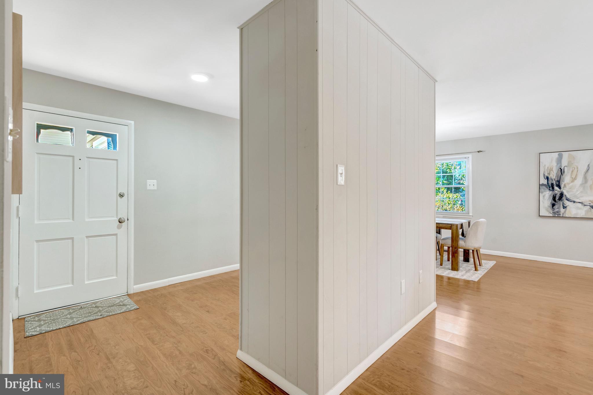 13128 Moss Ranch Lane Fairfax, VA 22033 - Photo 13 of 56 a view of a hallway with wooden floor and a living room