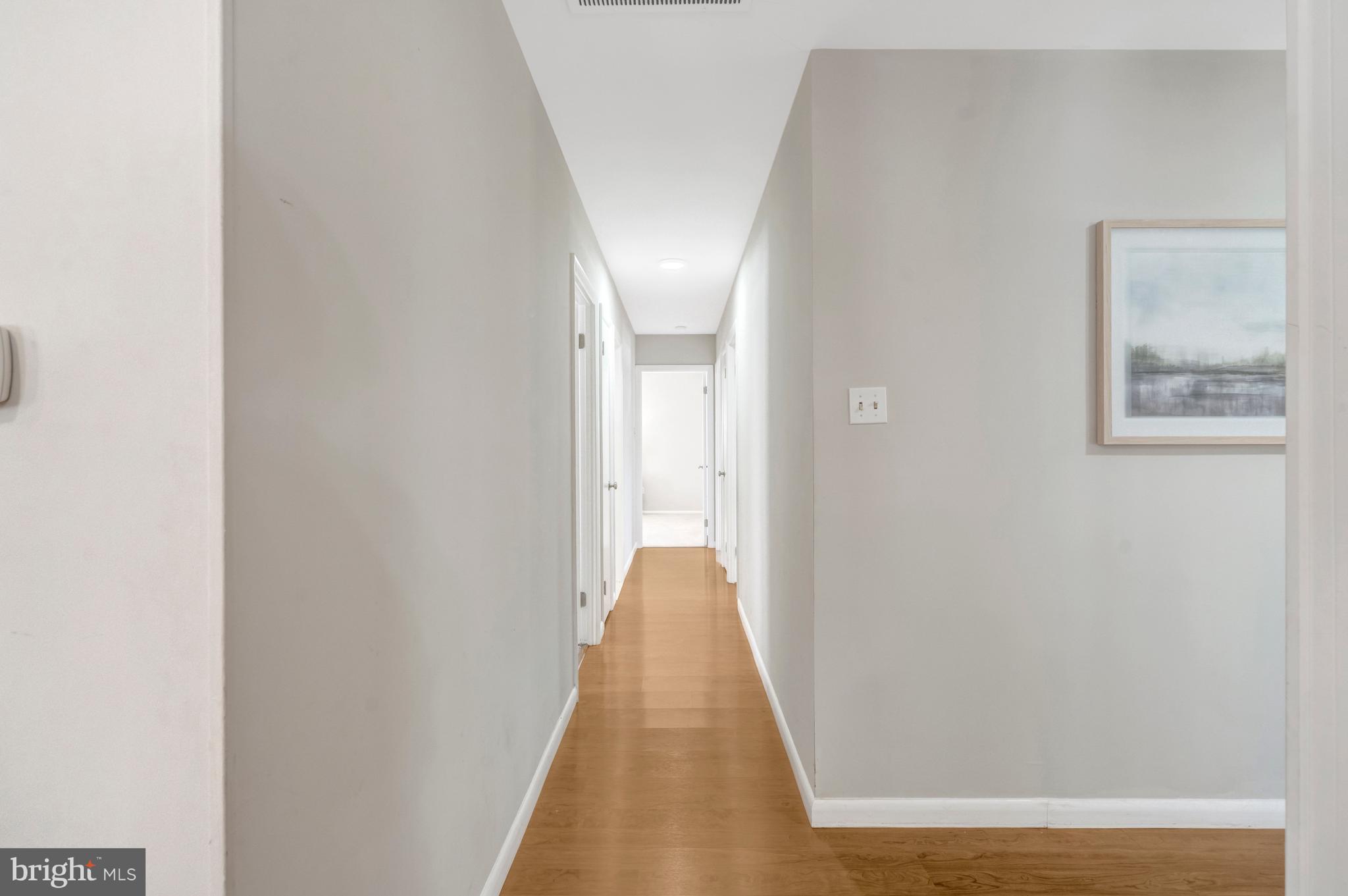 13128 Moss Ranch Lane Fairfax, VA 22033 - Photo 14 of 56 a view of a hallway with wooden floor