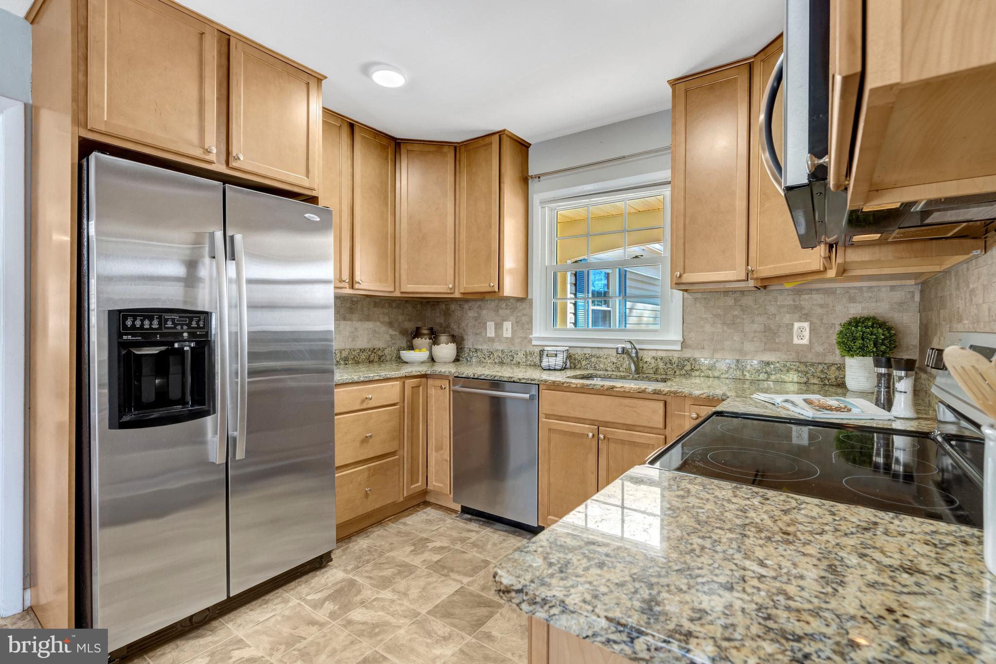 13128 Moss Ranch Lane Fairfax, VA 22033 - Photo 18 of 56 a kitchen with stainless steel appliances granite countertop a sink refrigerator and cabinets