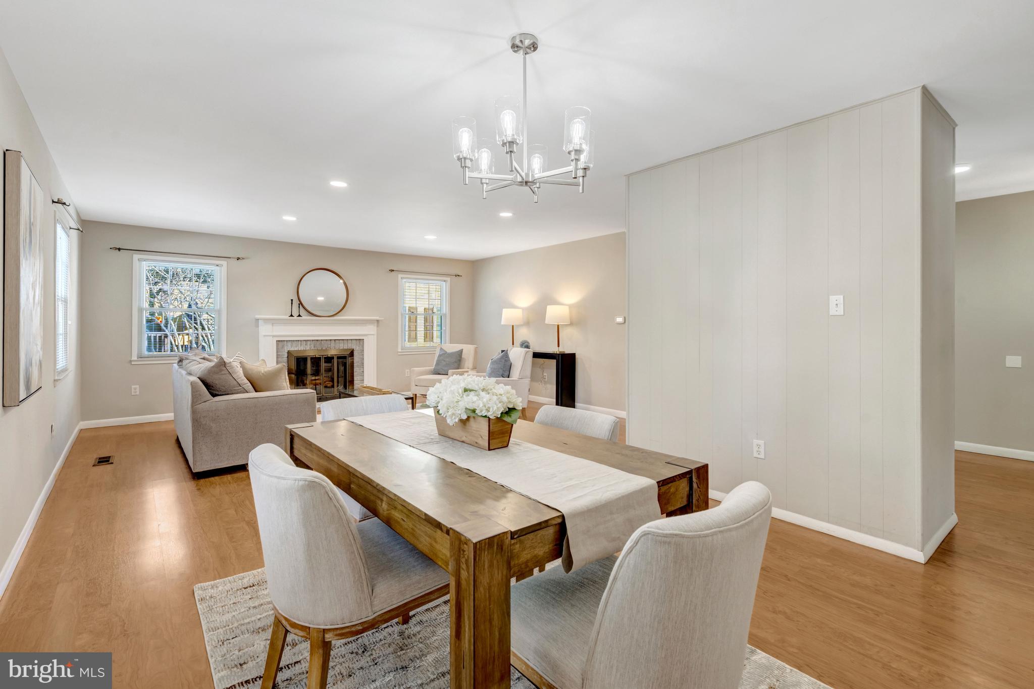 13128 Moss Ranch Lane Fairfax, VA 22033 - Photo 28 of 56 a view of a dining room with furniture wooden floor and chandelier