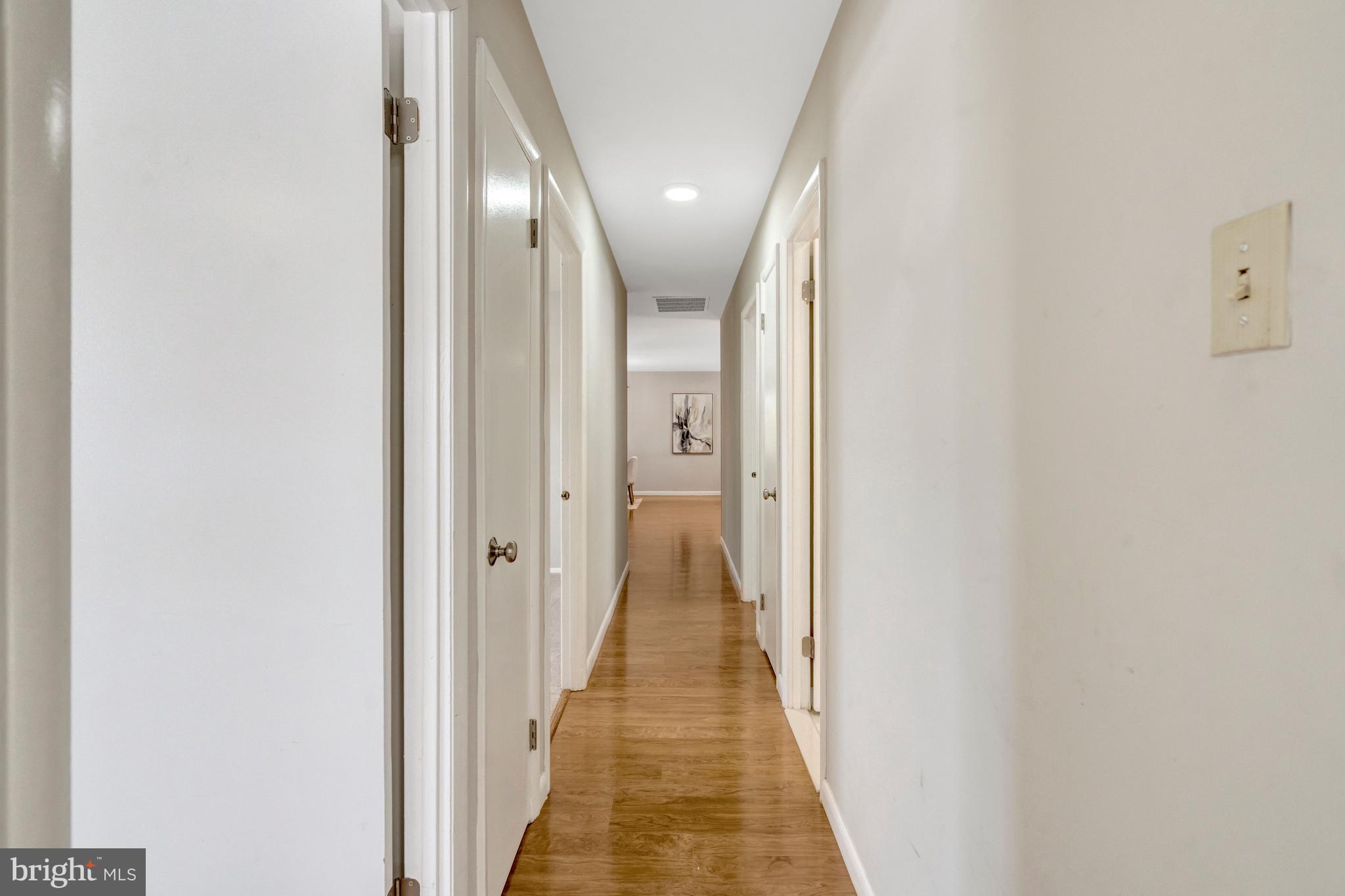 13128 Moss Ranch Lane Fairfax, VA 22033 - Photo 30 of 56 a view of a hallway with wooden floor