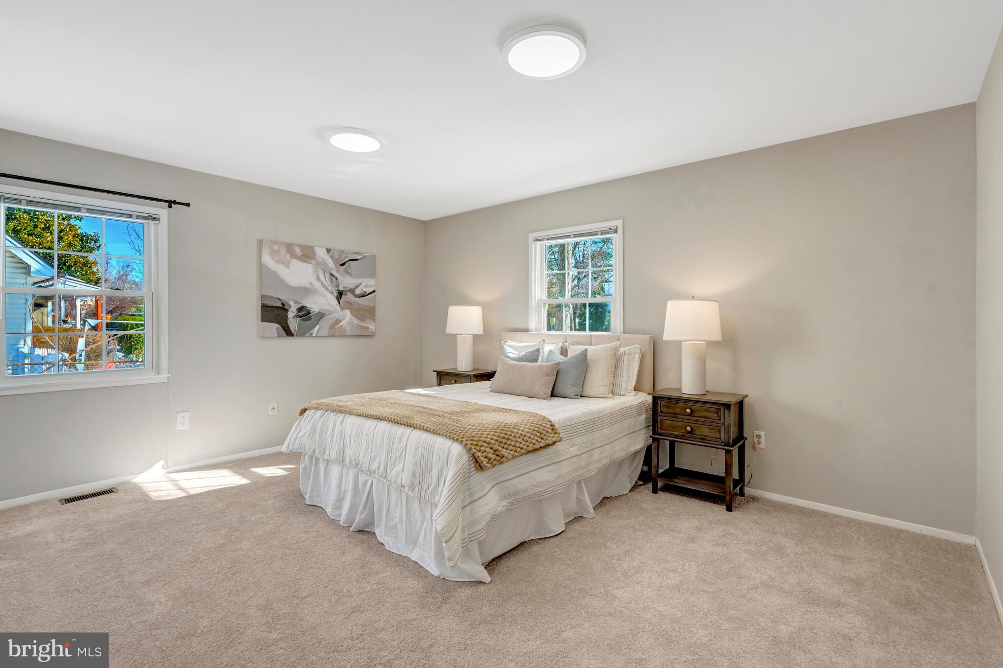 13128 Moss Ranch Lane Fairfax, VA 22033 - Photo 31 of 56 a spacious bedroom with a bed and a painting on the wall