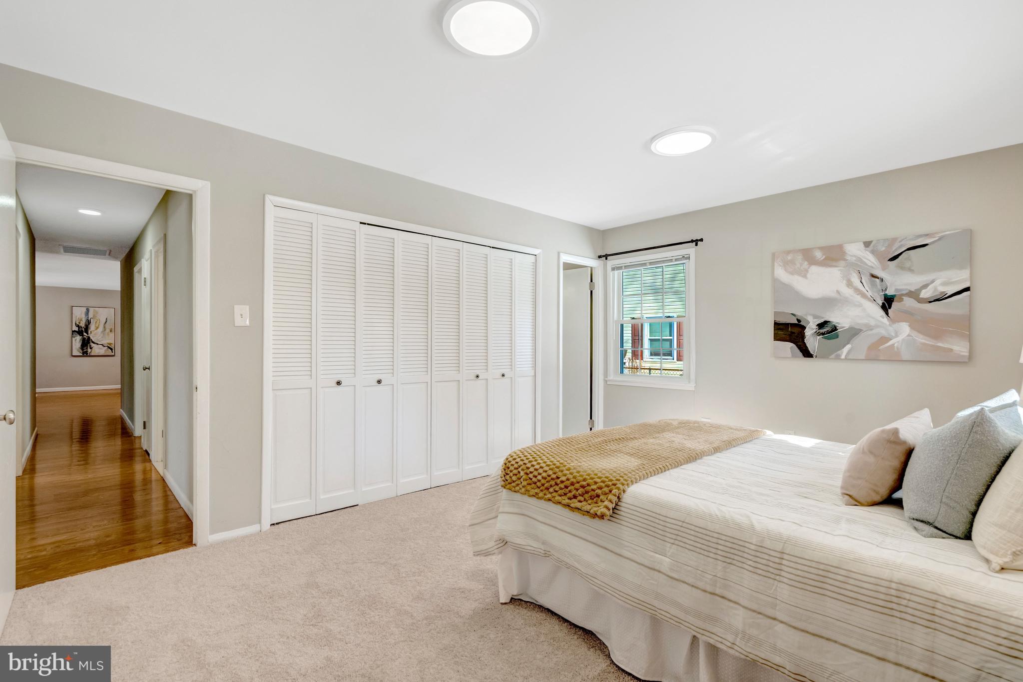 13128 Moss Ranch Lane Fairfax, VA 22033 - Photo 32 of 56 a bedroom with a large bed and a chandelier