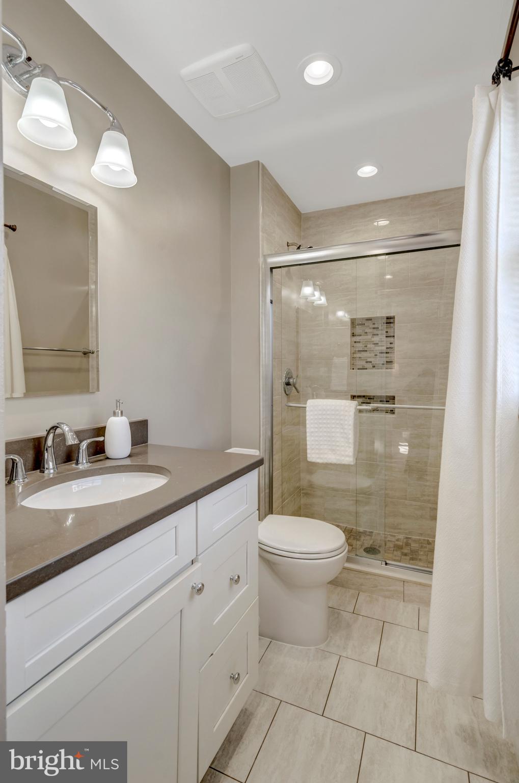 13128 Moss Ranch Lane Fairfax, VA 22033 - Photo 36 of 56 a bathroom with a sink a toilet and shower