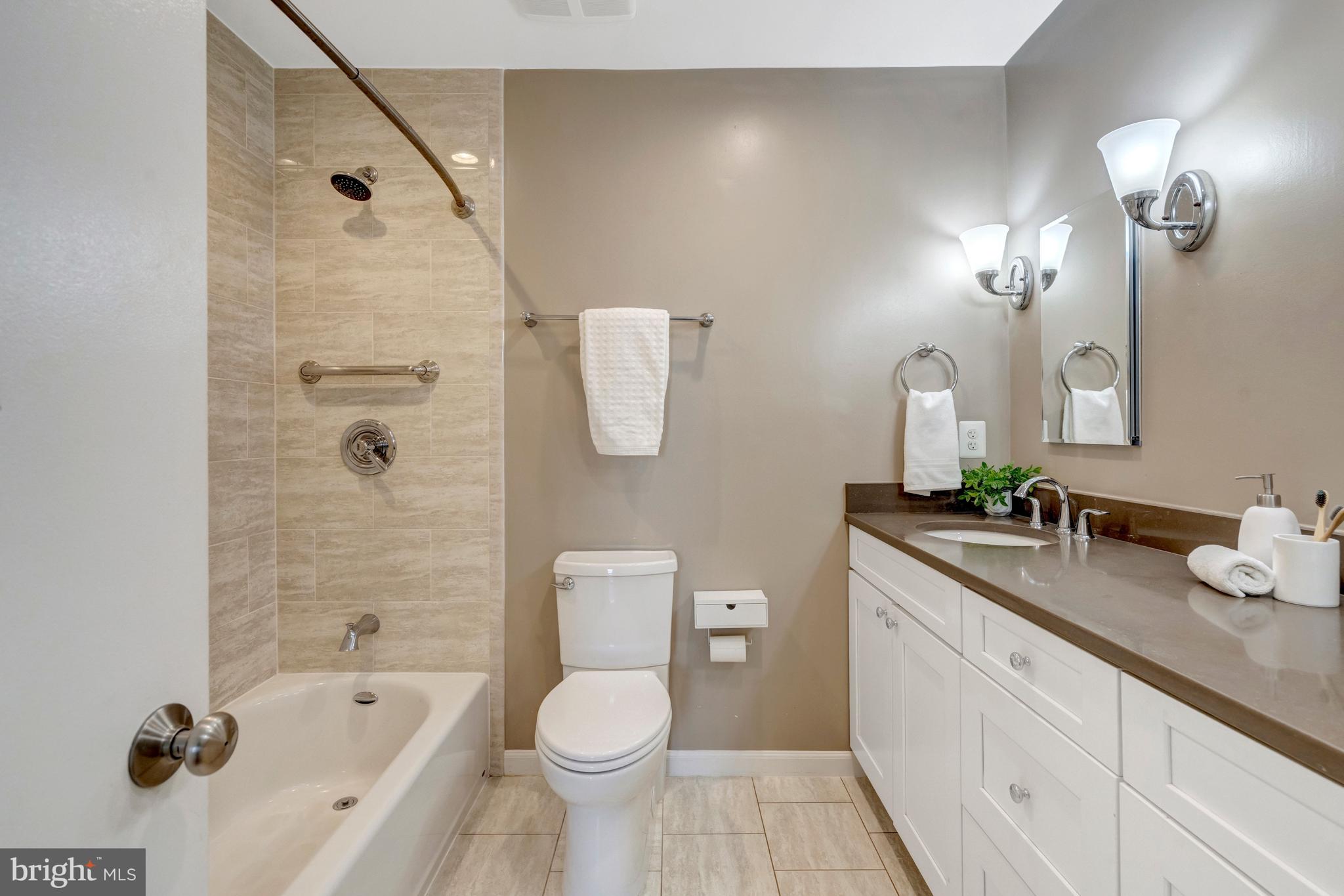 13128 Moss Ranch Lane Fairfax, VA 22033 - Photo 43 of 56 a bathroom with a granite countertop sink a toilet mirror and shower
