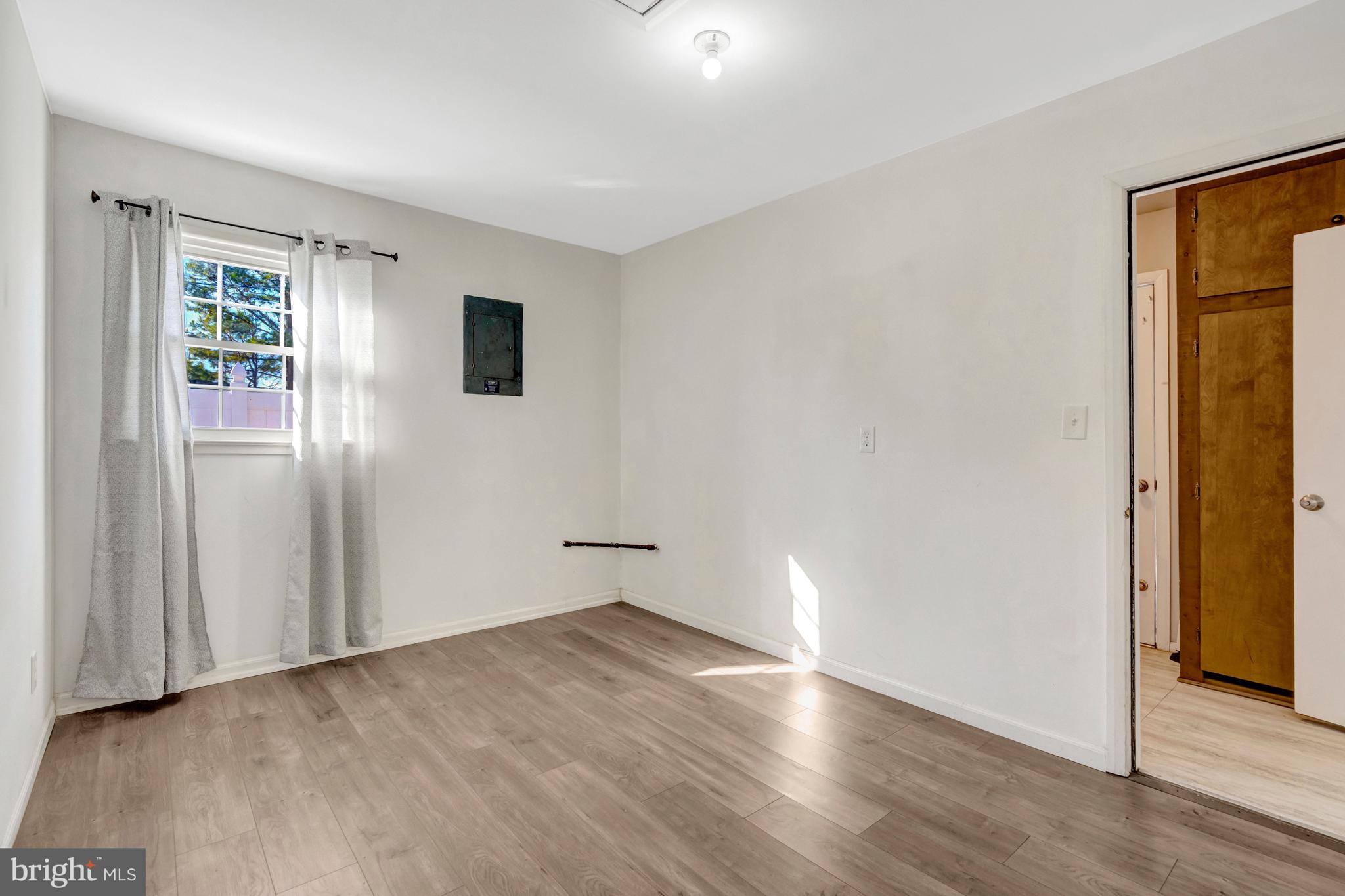 13128 Moss Ranch Lane Fairfax, VA 22033 - Photo 46 of 56 an empty room with wooden floor and windows