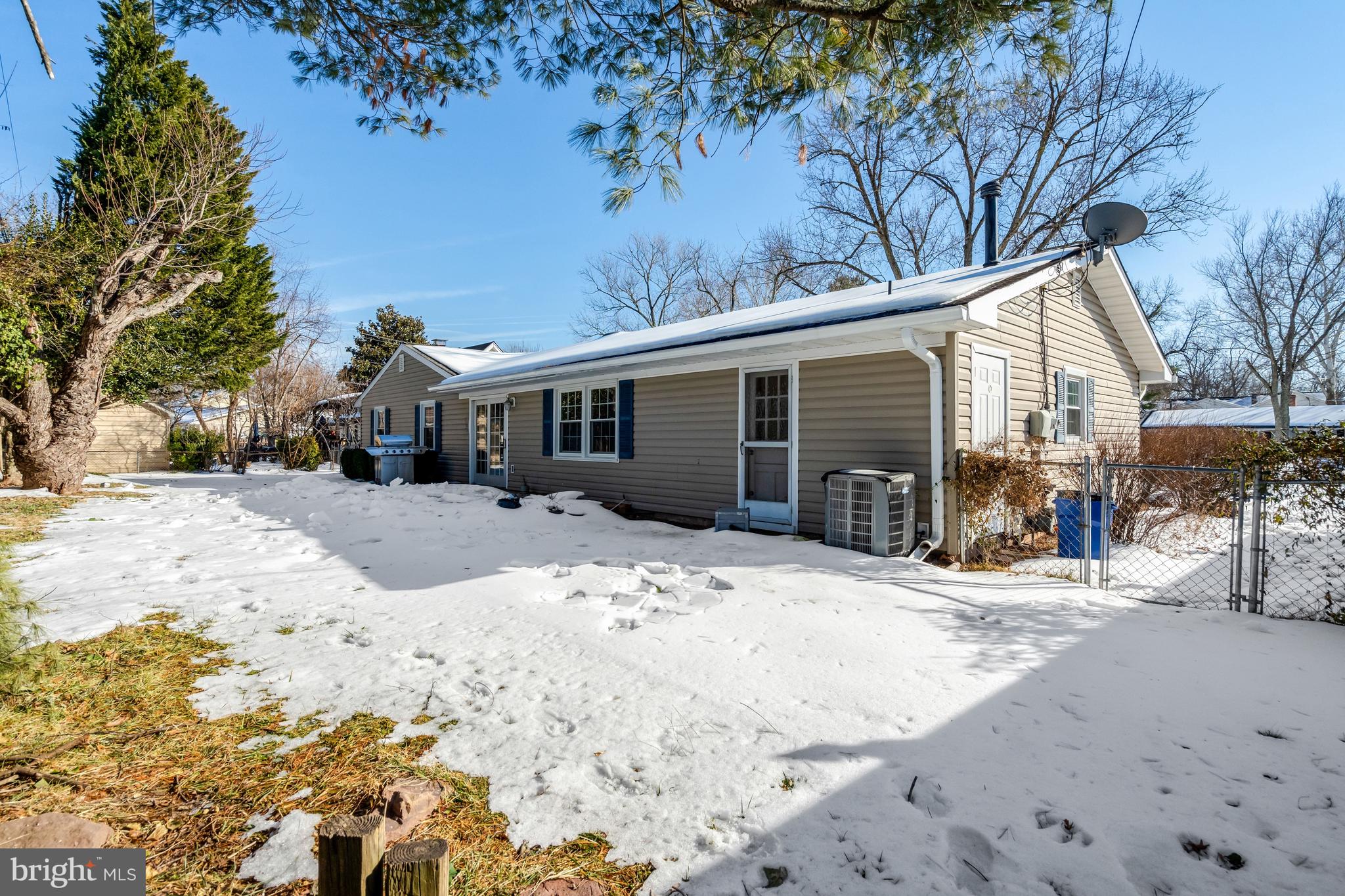 13128 Moss Ranch Lane Fairfax, VA 22033 - Photo 53 of 56 a backyard of a house with large trees and covered with snow