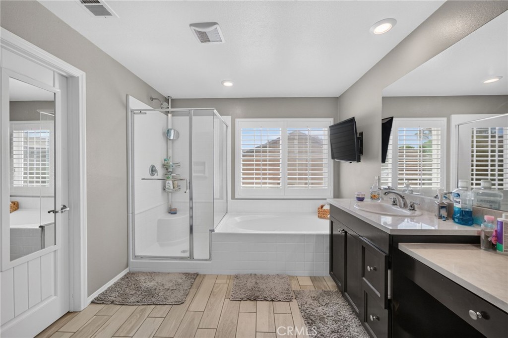 23347 Crystal Way Wildomar, CA 92595 - Photo 89 of 109 a bathroom with a tub sink shower and a mirror