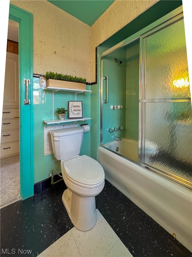 3110 Neosho Road Youngstown, OH 44511 - Photo 24 of 35 Bathroom with combined bath / shower with glass door, toilet, and tile floors