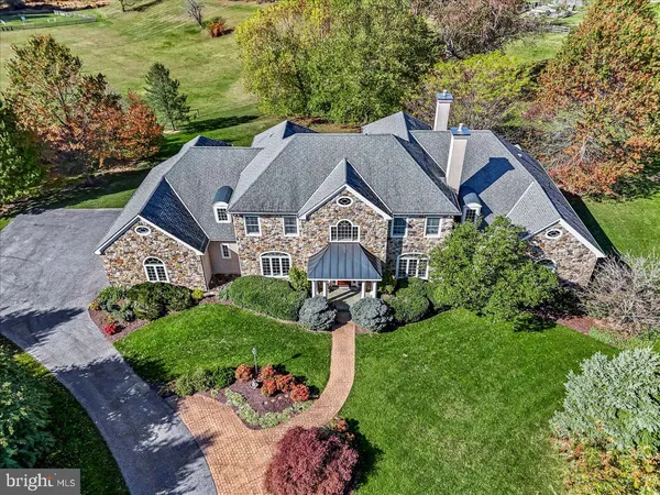 a aerial view of a house with a big yard plants and large trees
