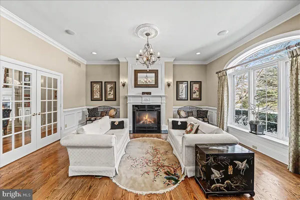 a view of a dining room with furniture a chandelier and wooden floor