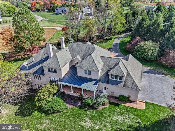 an aerial view of a house with a big yard