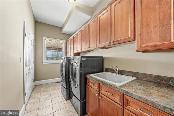 a large spacious bathroom with a large mirror and a sink