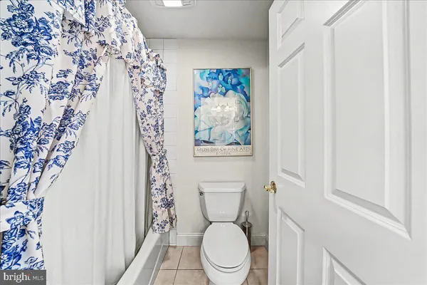 an aerial view of a houses with outdoor space and trees all around