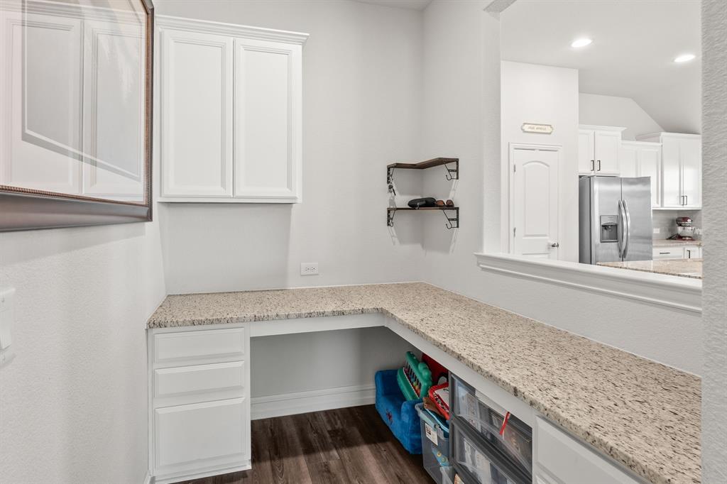 2920 Arlo Road Aubrey, TX 76227 - Photo 13 of 31 a kitchen with granite countertop a sink and a stove